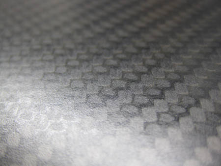 close-up of woven carbon-fiber epoxy laminate