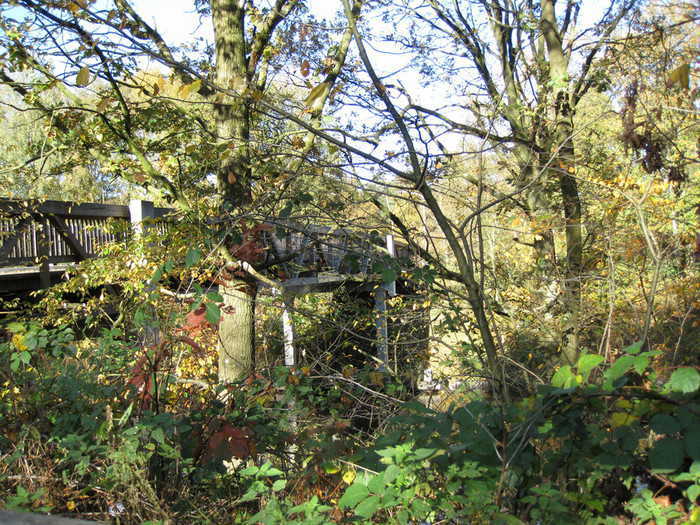 An unpainted wooden bridge.