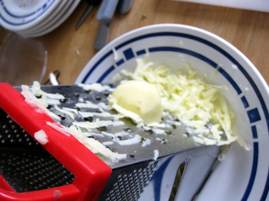 grating the potatoes